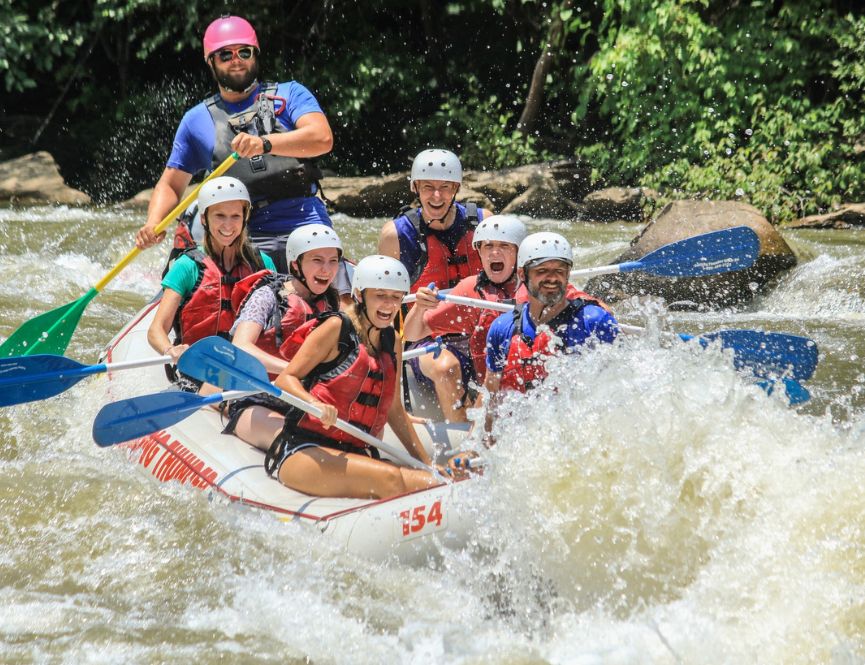 Family paddling a rapid on an Ocoee river rafting trip.