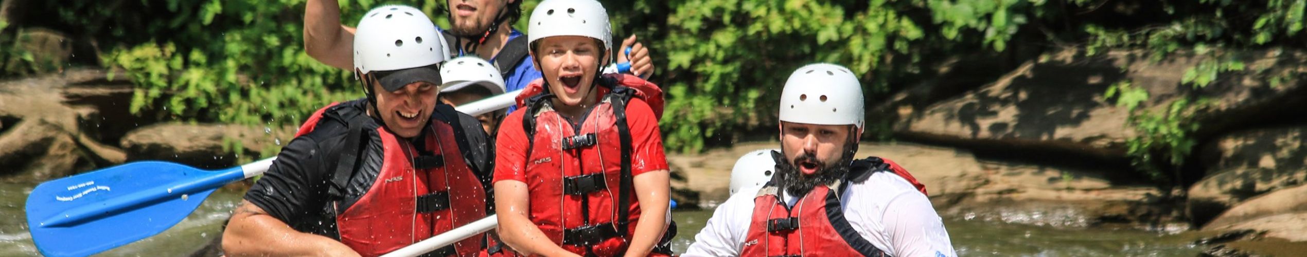 kid riding on front of Ocoee river raft